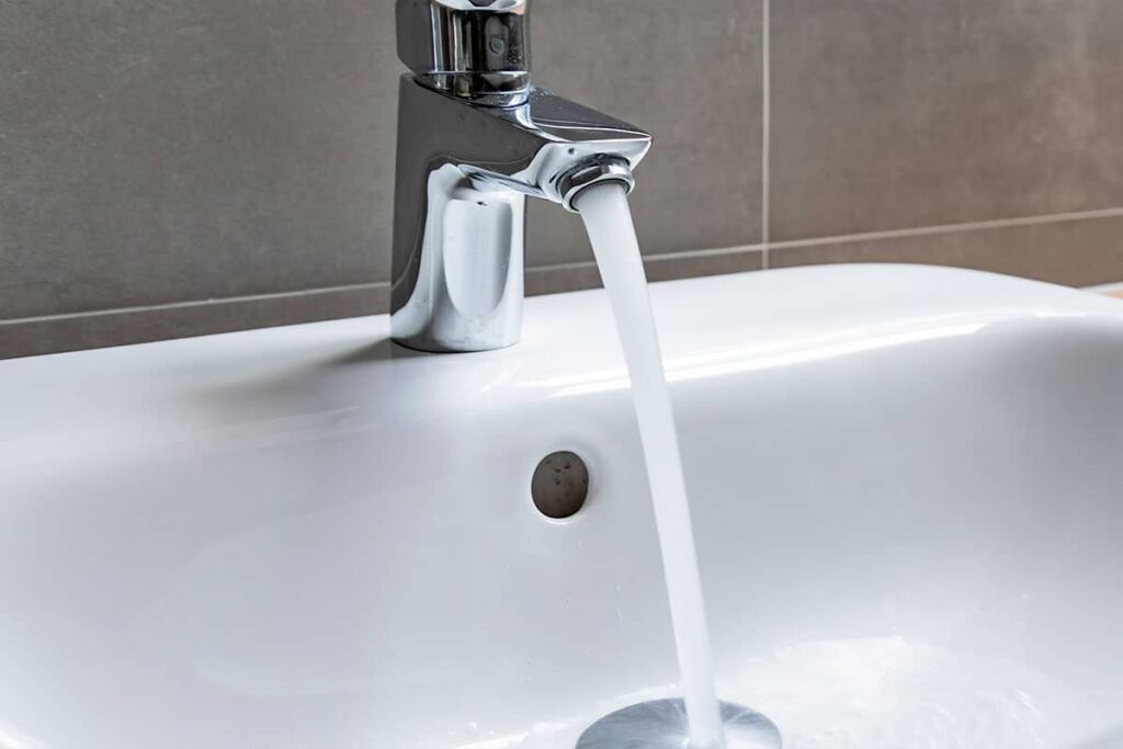 Modern bathroom faucet with running water