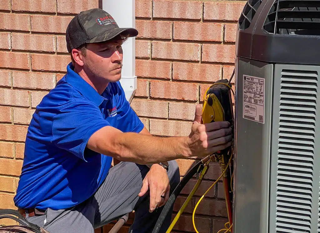 Air conditioning technician servicing an outdoor AC unit