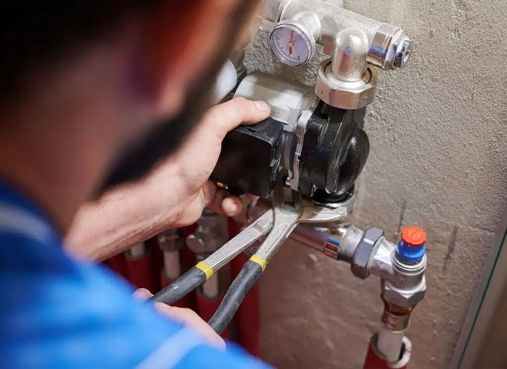 Plumbing technician repairing residential plumbing connections