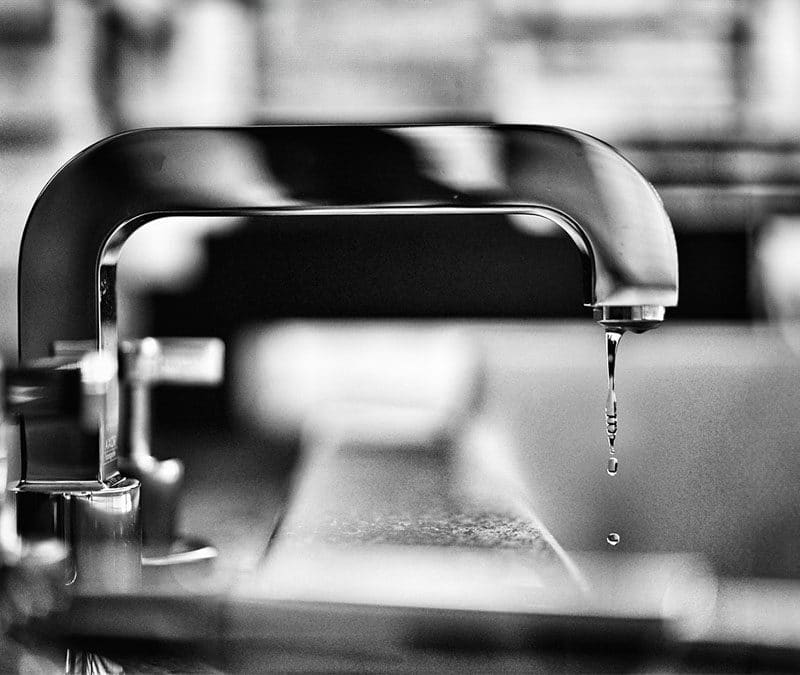 Modern kitchen faucet with a dripping water leak