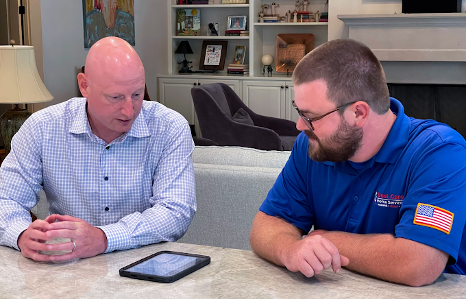 Plumbing professional discussing piping plans with a homeowner in Huntsville, AL.