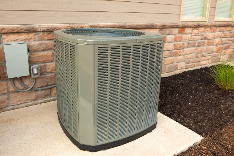 Outdoor residential heat pump system installed beside a home, representing heat pump rebate options in Orange County.